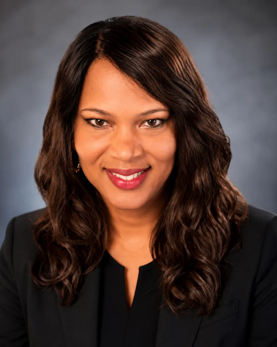 Portrait of Janelle Wright wearing black against a neutral background