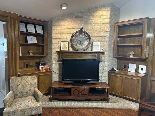 Comfortable living room with a fireplace, seating, and built-in shelving